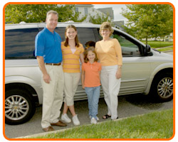 photo of a family in front of a minivan